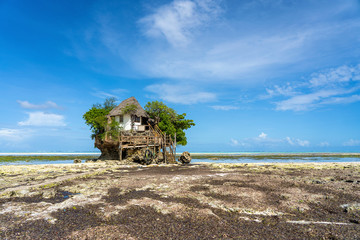 Home on the rock at low tide on the island of Zanzibar, Tanzania, east Africa - obrazy, fototapety, plakaty