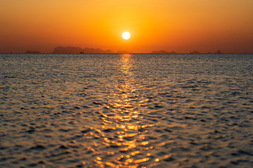 Beautiful sunset over the sea water on the island of Koh Phangan, Thailand. Travel and nature concept