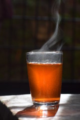 A cup of freshly brewed black tea,escaping steam