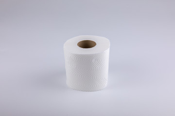 The unused white tissue roll was taken in a studio shot on a white background, with detailed details on the surface, the waves and perforations looking soft and providing comfort to users.