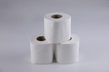The three unused toilet paper rolls were placed vertically like a pyramid, shot on white background  reminiscent of the concept of being together with supporting from others, such as family or friends