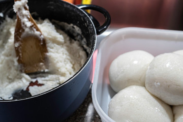 Nigerian Tuwo Shinkafa prepared in a pot with a wooden Spatula