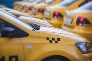 View of yellow taxi cab parking lot with yellow cars standing, set of taxicabs in the streets, taxis