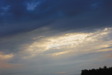 Fototapeta premium gloomy stormy sunset sky with dark clouds