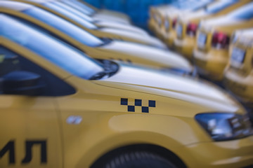 View of yellow taxi cab parking lot with yellow cars standing, set of taxicabs in the streets, taxis