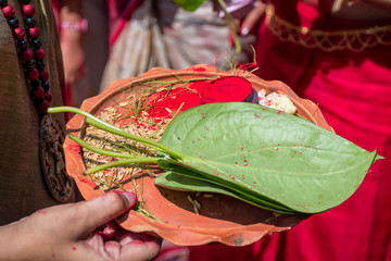 Woman holding a ceremonial plate used for worshipping God, during Sindur Khela at a puja pandal on...