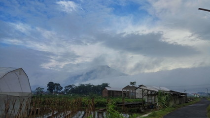 barn in the countryside with fog and mountain background