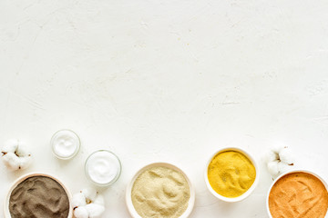 Clays set for face mask on white table top-down frame copy space
