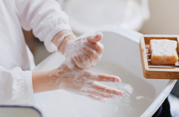 Little girl washing hands rubbing with soap for corona virus prevention, hygiene to stop spreading coronavirus. Wash yours hand to stop covid-19. Close up. Cleans your hand.