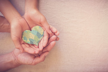 Hands holding leaf heart shape, CSR social responsibility, eco sustainable living, vegan, world...