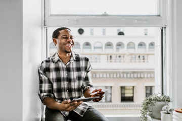 Cheerful man in a window