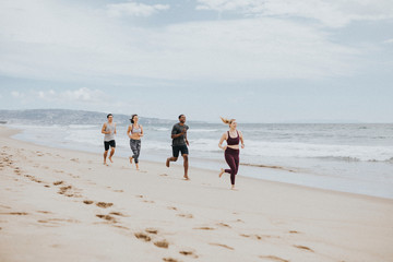 Fit people jogging on the beach