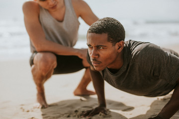 Man training by the beach