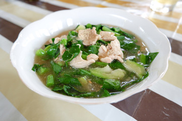 Fried noodle with pork and kale in a bowl.
