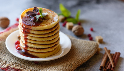 Delicious fresh beautiful pancakes with citrus honey and jam