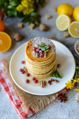 Delicious fresh beautiful pancakes with citrus honey and jam