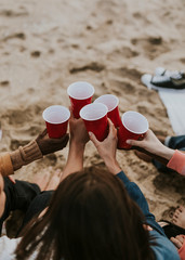Friends drinking by the beach