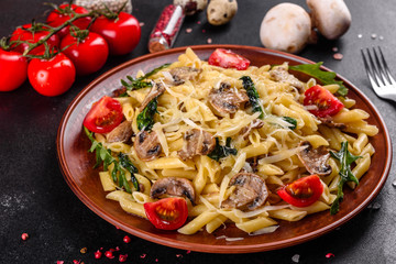Pasta with mushrooms, cheese, spinach, rukkola and cherry tomatoes