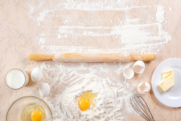 Kitchen table with ingredients for cooking baking. Copy space. Cooking concept. Eggs, flour on background. Dough ingredients.