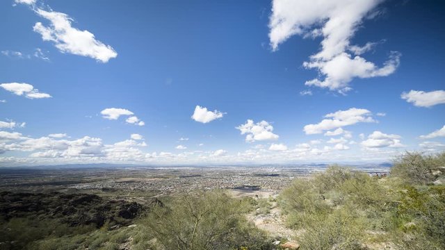 Phoenix, Arizona - March 14 2020: Looking across Phoenix from a lookout in a wide timelapse as clouds flow overhead.
