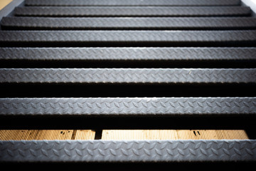 black steel staircase attached to the building . abstract iron background.