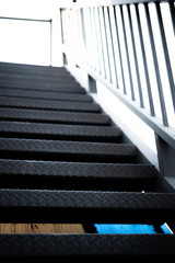 black steel staircase attached to the building . abstract iron background.