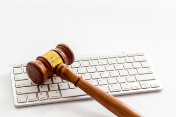 Judge hammer, keyboard on white lawyer's desk space for text
