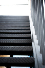 black steel staircase attached to the building . abstract iron background.