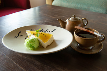 Passion Fruit Cheesecake and lime ice cream Served with a cup of hot aromatic tea