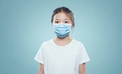 Asian little girl wearing a protective hygiene protective mask