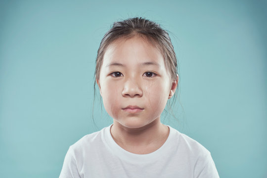 Portrait Of Melancholy Sad Crying Little Asian Girl.