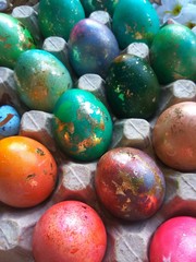 Colorful painted easter eggs with green leaves and decor