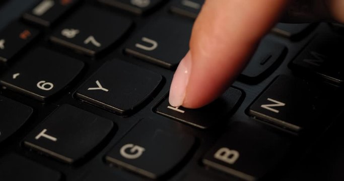 Pushing H button on the black keyboard. English letters. Used Macro lens and slow-mo.