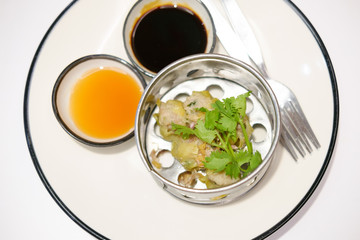 Chinese Steamed Dumpling  on white dish served with Chili sauce and Soy sauce Dimsum pork