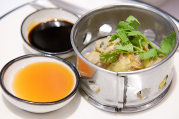 Chinese Steamed Dumpling  on white dish served with Chili sauce and Soy sauce Dimsum pork