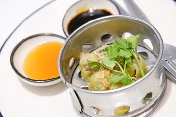 Chinese Steamed Dumpling  on white dish served with Chili sauce and Soy sauce Dimsum pork