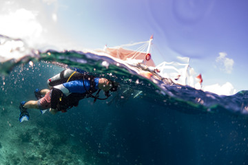 Scuba diver exploring Philippine dive sites in Moalboal.