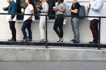 Diverse people standing in line