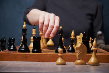 Businessman hand moving of playing chess strategyconcept: symbol confident new strategy plan for win and success, sports game thinking battle planning object achievement queen for successful