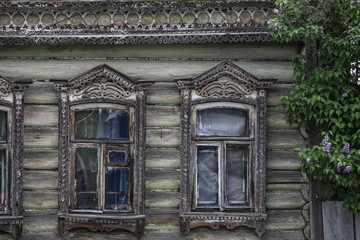 old russian traditional house with windows with plat bands