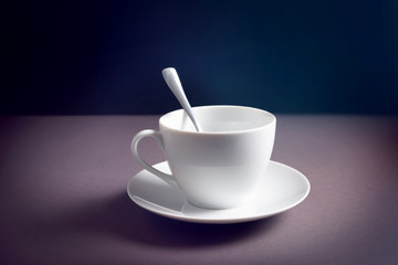 White Cup and saucer on a dark background. The concept of Breakfast.