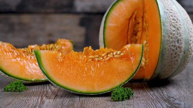 fresh melon slices on wood background