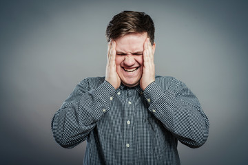 Fototapeta premium A young man having a headache