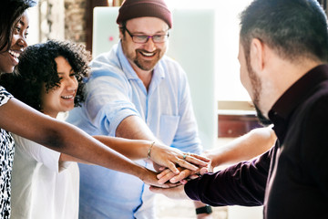 Diverse startup business team stacking hands