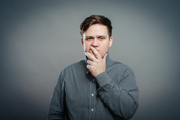 Man holding his nose against a bad smell