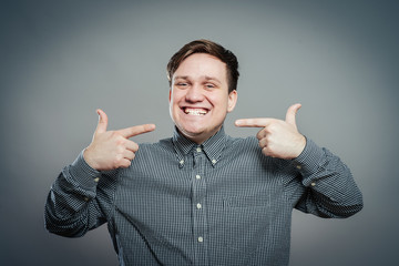 portrait of handsome young man showing on his teeth