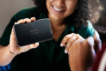 Woman displaying a phone mockup