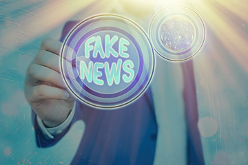 Conceptual hand writing showing Fake News. Concept meaning false information publish under the...