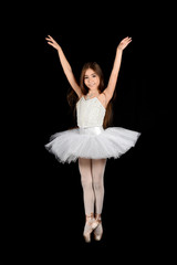 Fototapeta na wymiar girl dancing with white tutu on black background