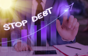 Conceptual hand writing showing Stop Debt. Concept meaning does not owning any money or things to...
